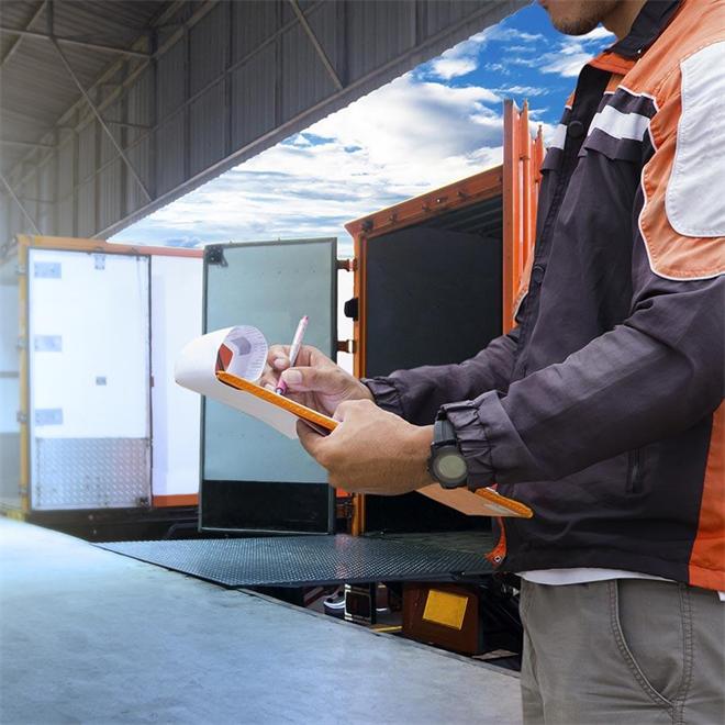 Logistics worker reviewing customs documents for an international DDP shipment