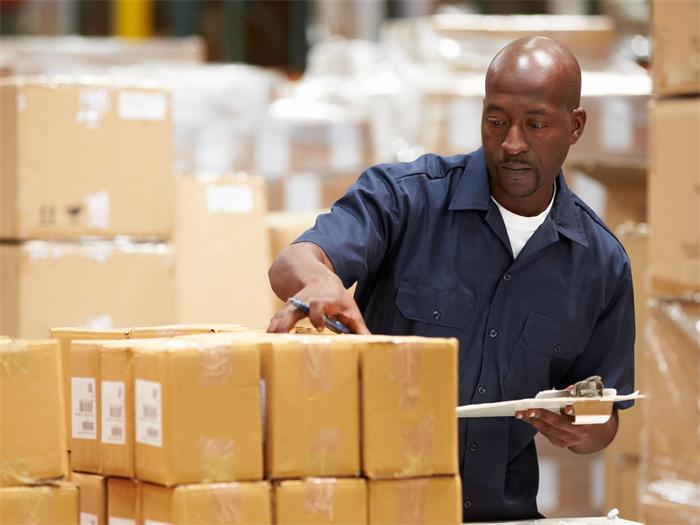 Warehouse staff measuring product dimensions during a basic inspection