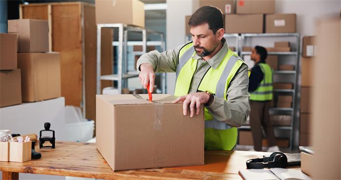 Warehouse worker matching supplier packages with customer tracking references