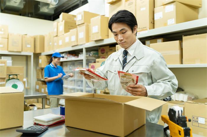 Warehouse worker performing a basic product inspection on supplier packages