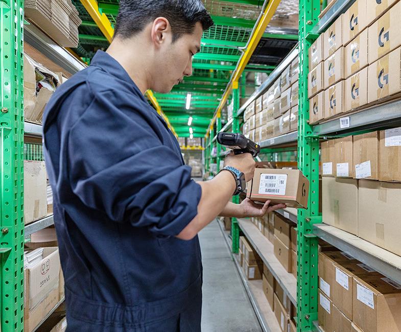 warehouse employee scanning package barcode during receiving process