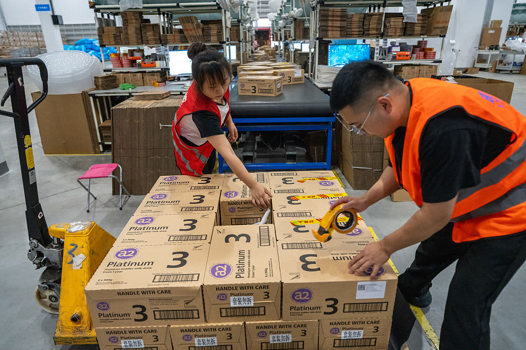 China warehouse workers repacking cartons for international DDP shipping