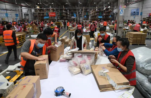 Chinese ecommerce warehouse preparing consolidated orders before international shipping